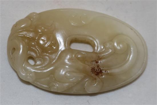 A Chinese archaistic white and pale russet jade oval disc, 4.9cm